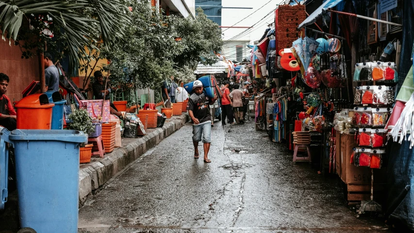 an open street market with people walking down it