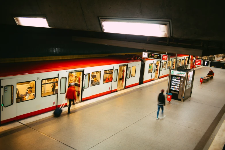 a man walks past a train stopped at a train station