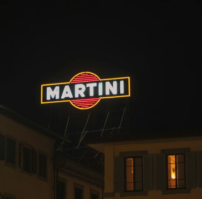 a lit up neon sign above an office building