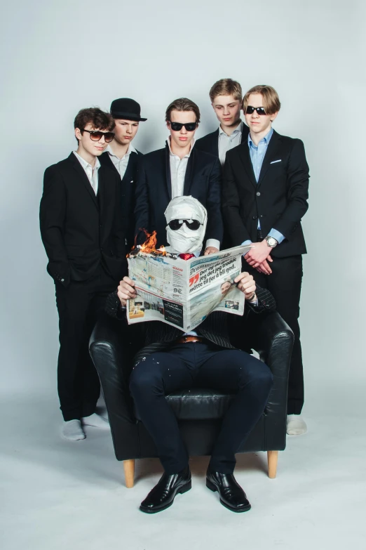 four people pose for the camera while wearing sunglasses