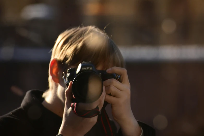 a person holds a camera up with one hand