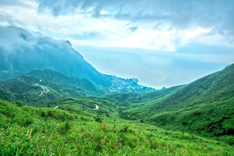 there is an empty valley with a few hills in the distance