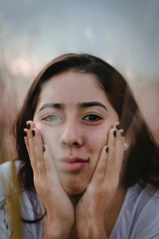 a woman holding her hands to her face