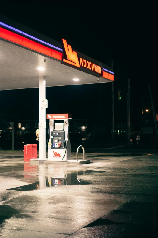 a gas pump is at night with its lights on