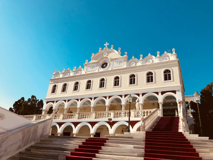 a long white building with red steps leading up to it