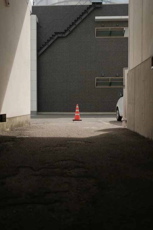 a bright red fire hydrant next to an industrial building