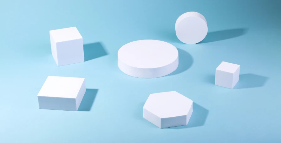 white plastic objects scattered around on a blue background