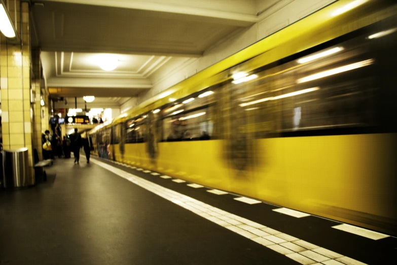 two people walking by a subway car at the station