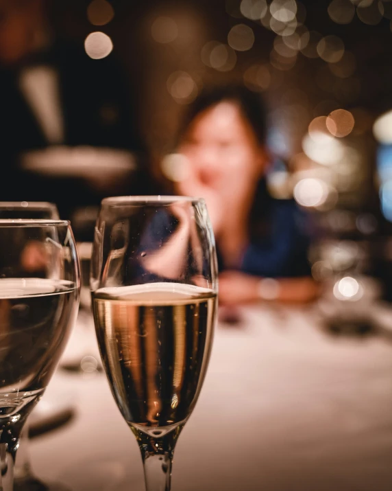 a close up of two wine glasses on a table