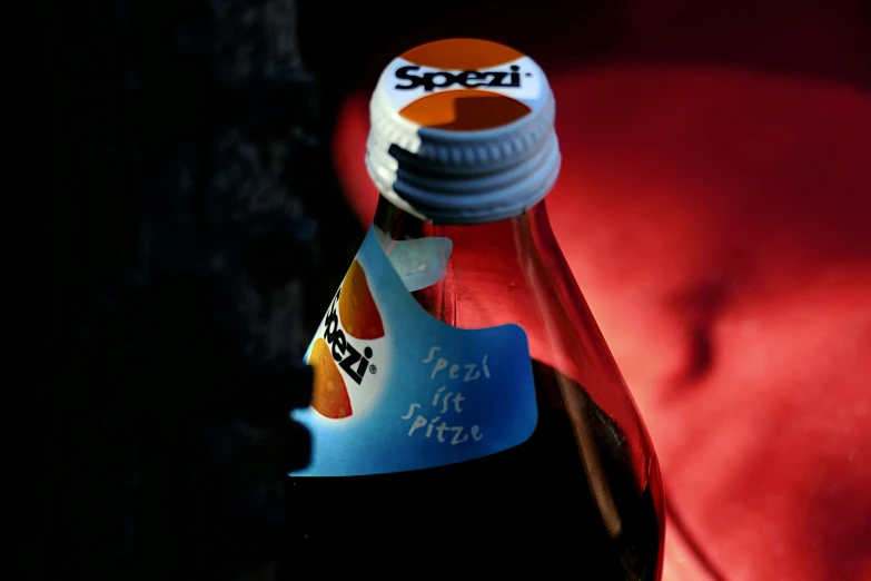 a close up of an orange soda bottle