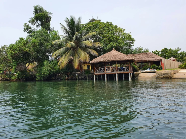 people are sitting on the porch over the water