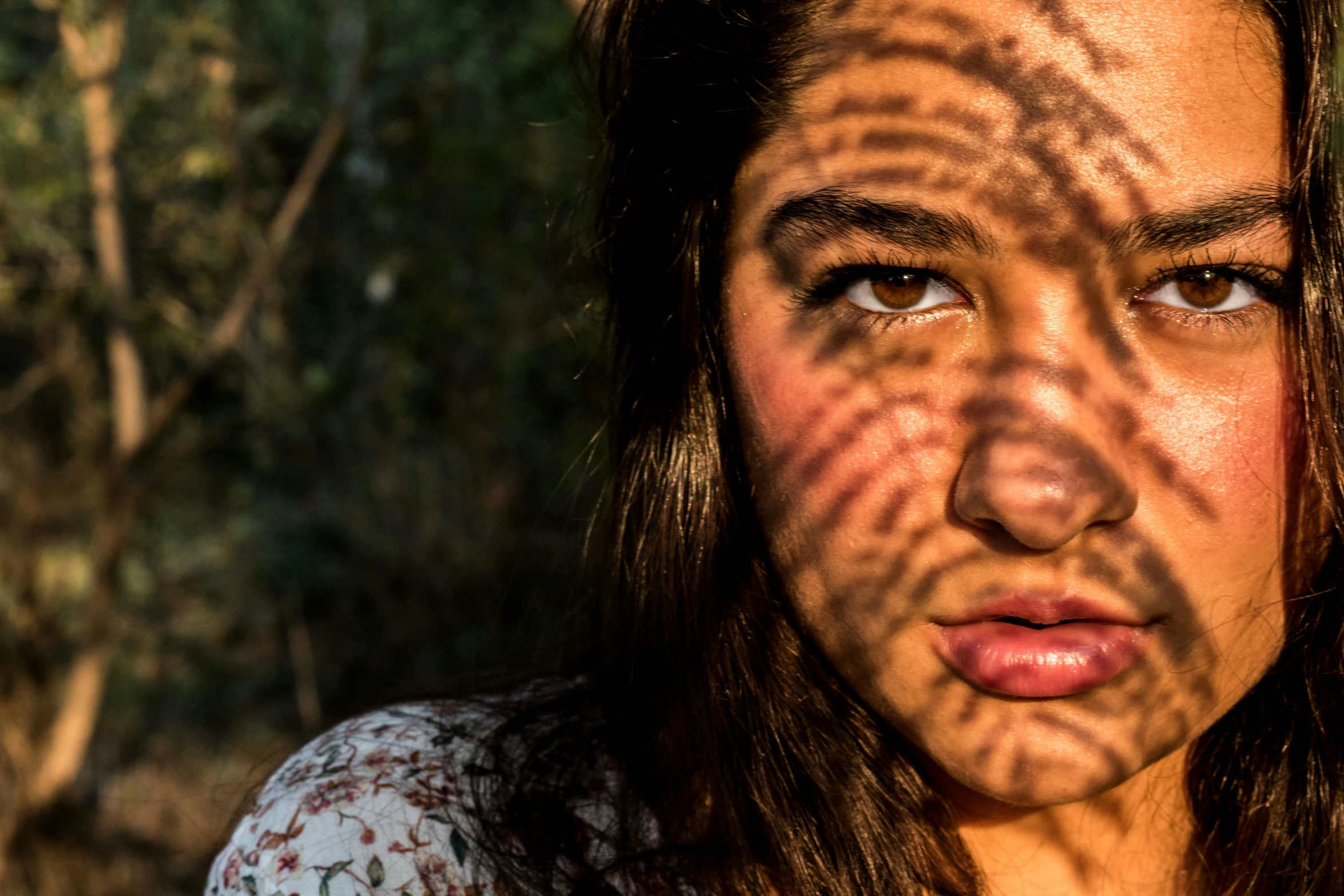 a young woman's face shows her sun painted on her body