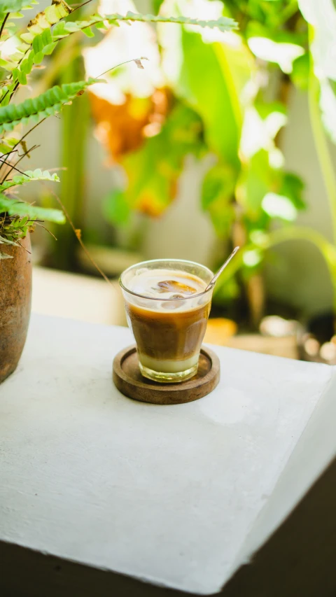 a small cup of coffee sits on a saucer