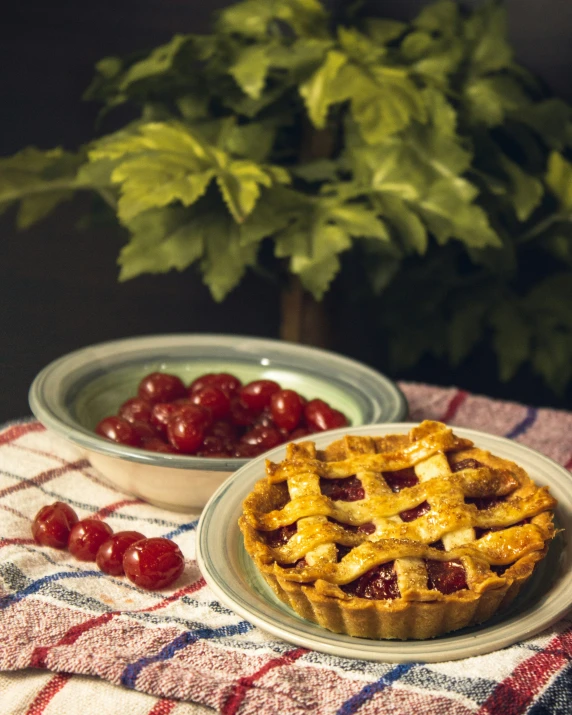 a plate with a pie, bowl of cherries and an american flag cloth