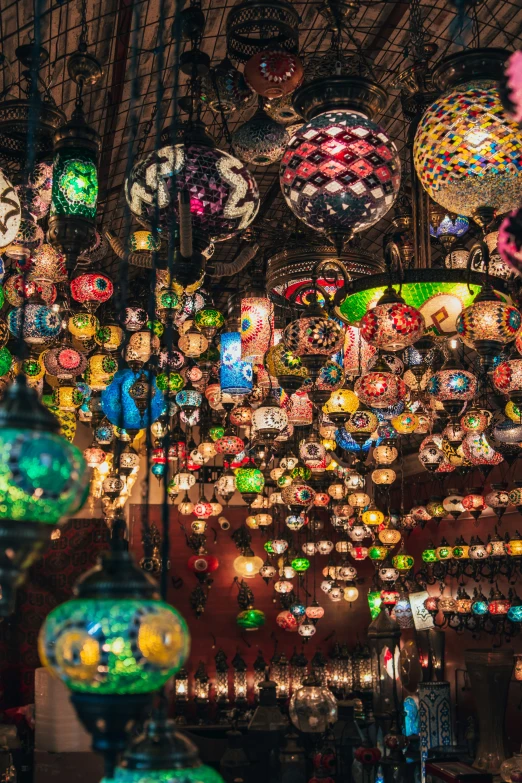 a shop filled with different kinds of lights hanging from the ceiling