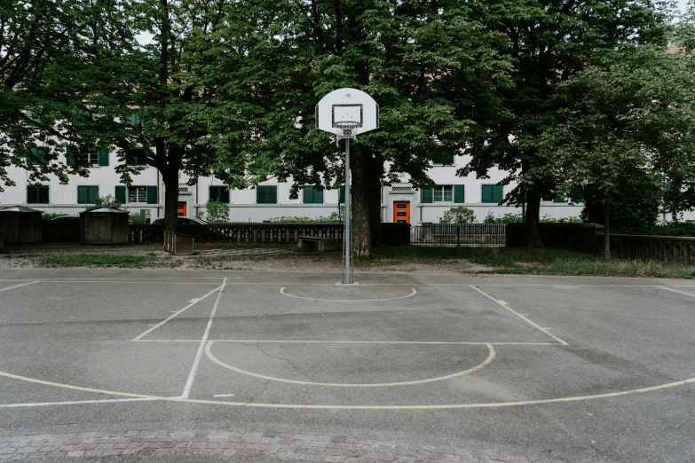 a basketball hoop is shown near a white building