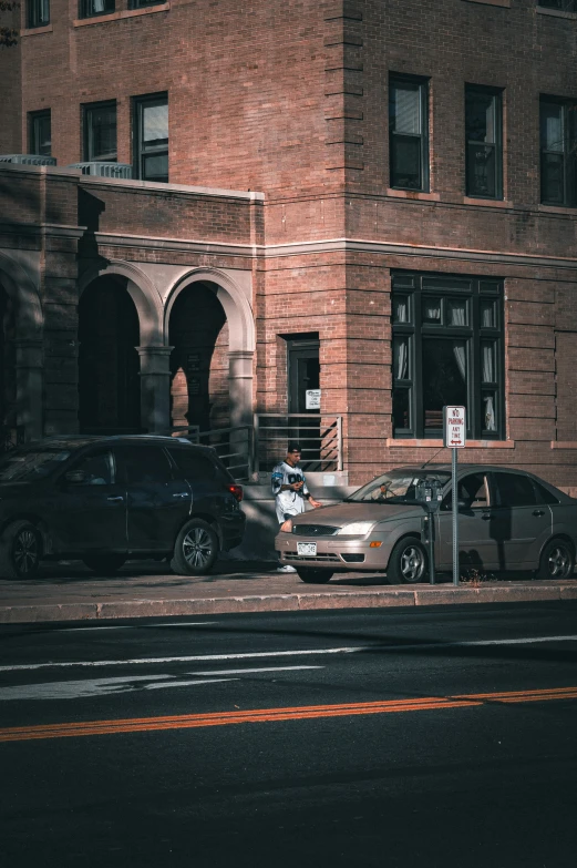 parked cars parked outside an old brick building at night