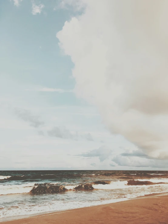 some surfers are walking on the ocean shore