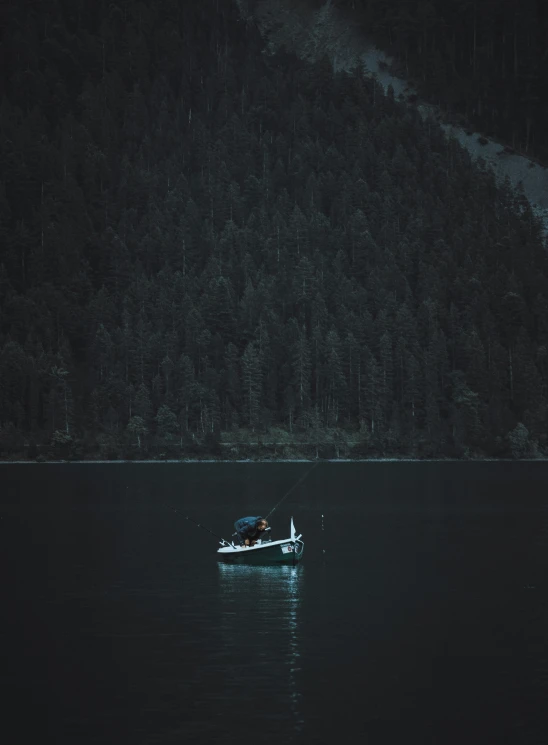 a person riding in a rowboat at night