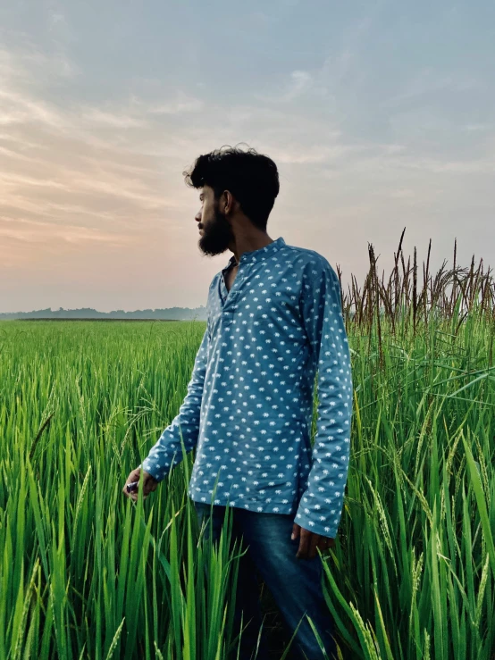 a man standing in a field of tall grass