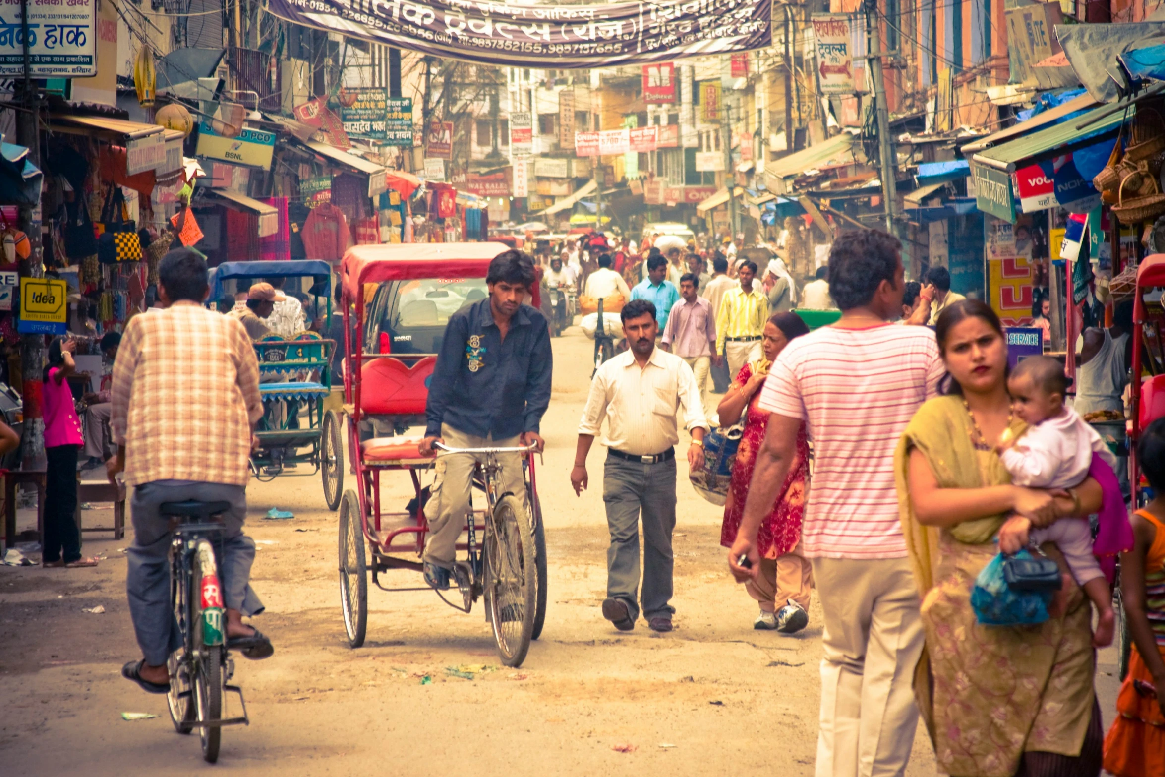 a crowded street filled with people and bicycles