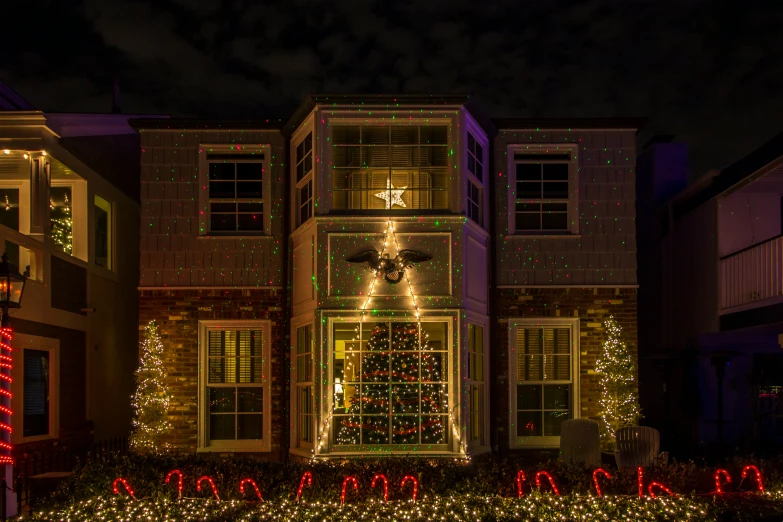 christmas decorations on windows and balconies around a lighted tree