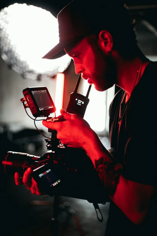 a man wearing a hat and holding a camera