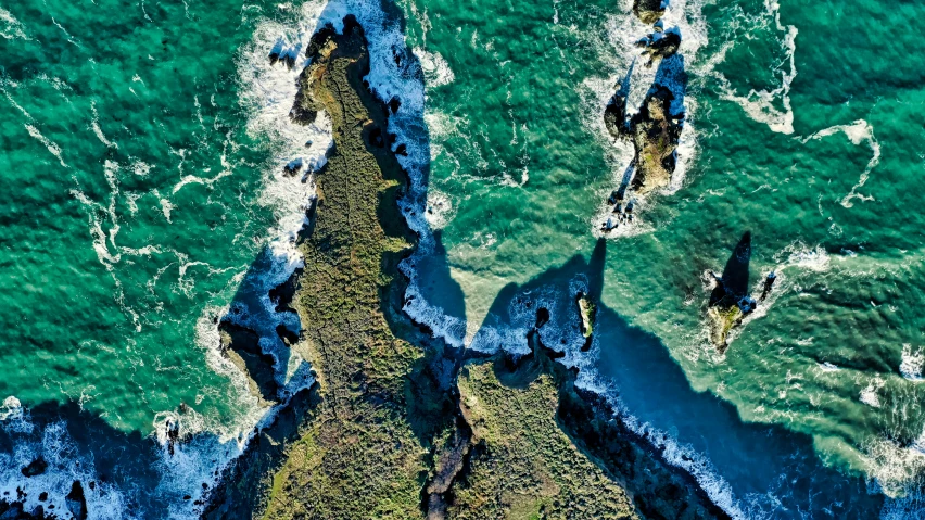 two large rocks sticking out of a sea