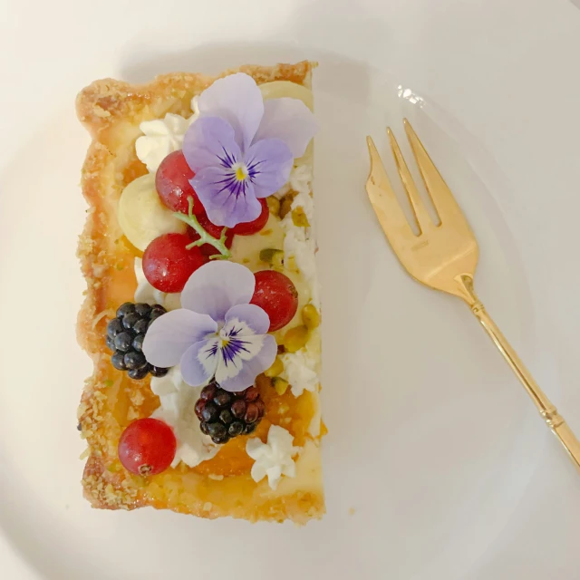 a slice of bread topped with fruit and flowers