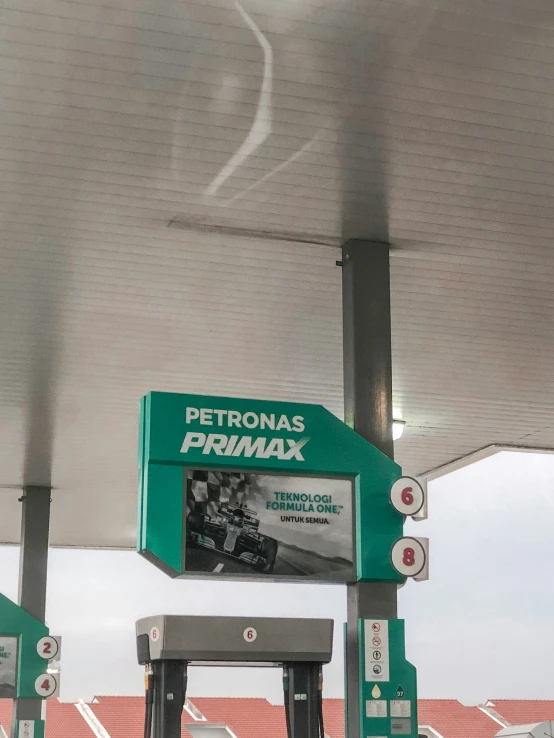 a gas station sign for petronias primaax and the company name is written on it