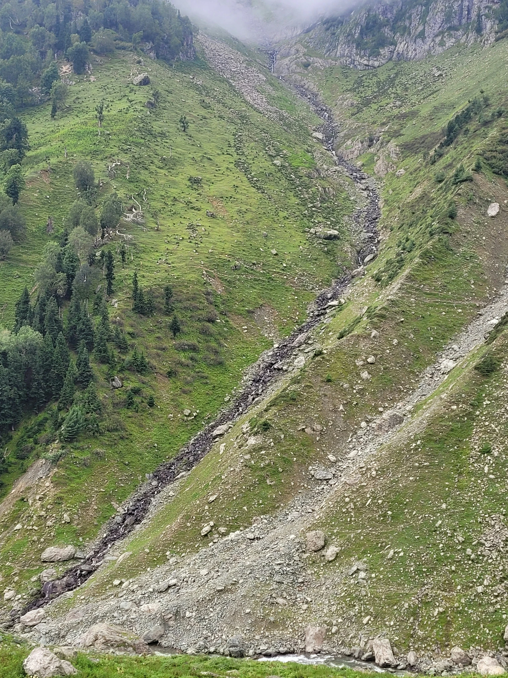 a mountain with a stream coming down it's side