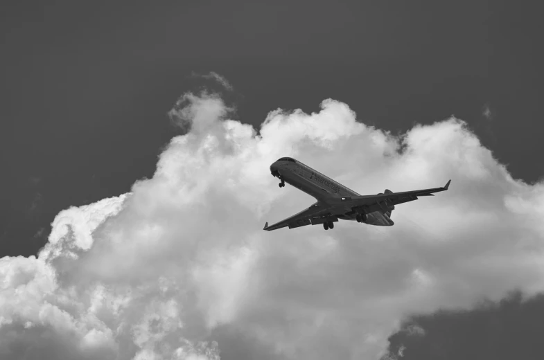 an airplane is flying in the cloudy sky