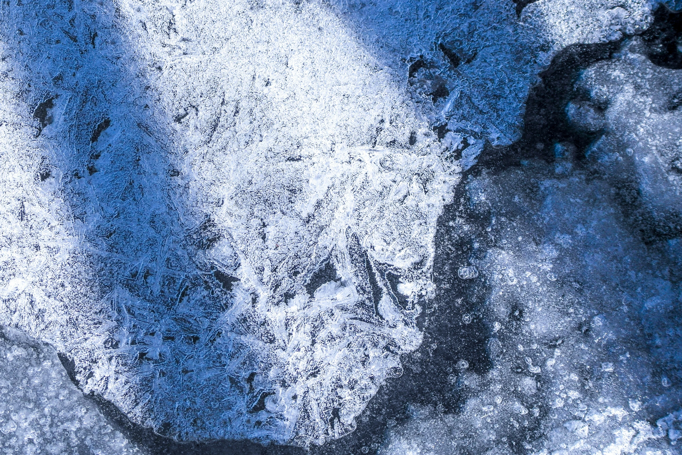 a white snow covered ground next to two footprints