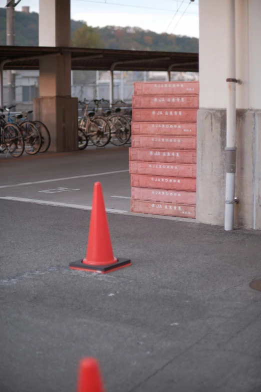 a cone is sitting next to some pink bricks