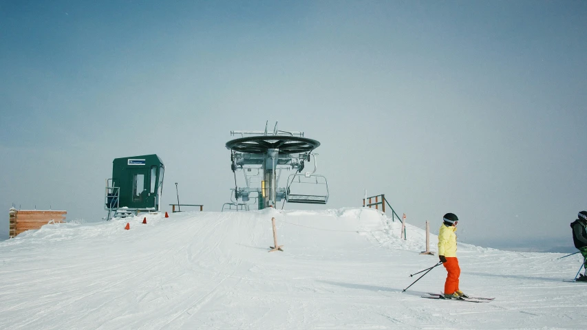 skiers in front of a ski lift in the snow