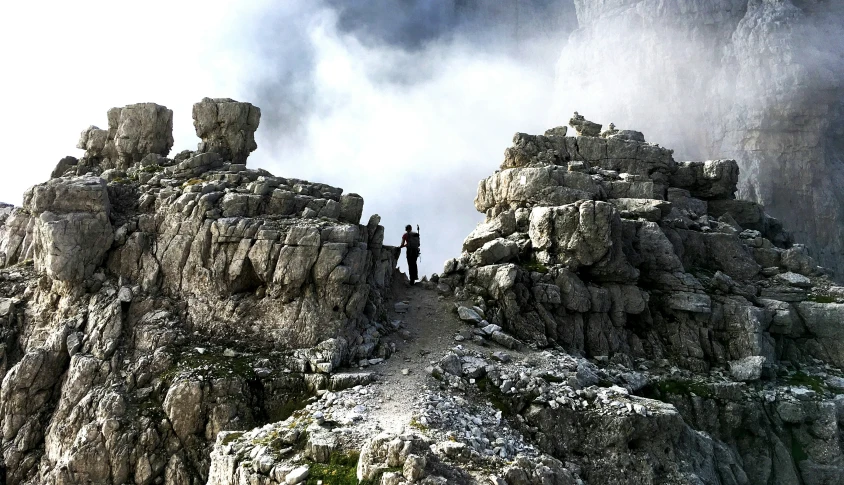 some rocks and a person on a rocky hill