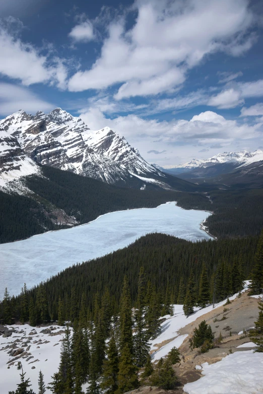 there is a lake below the mountains with snow