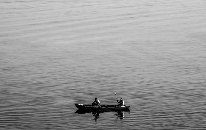 two people in a boat on the water