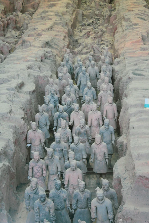 a group of statues sitting on top of some rocks