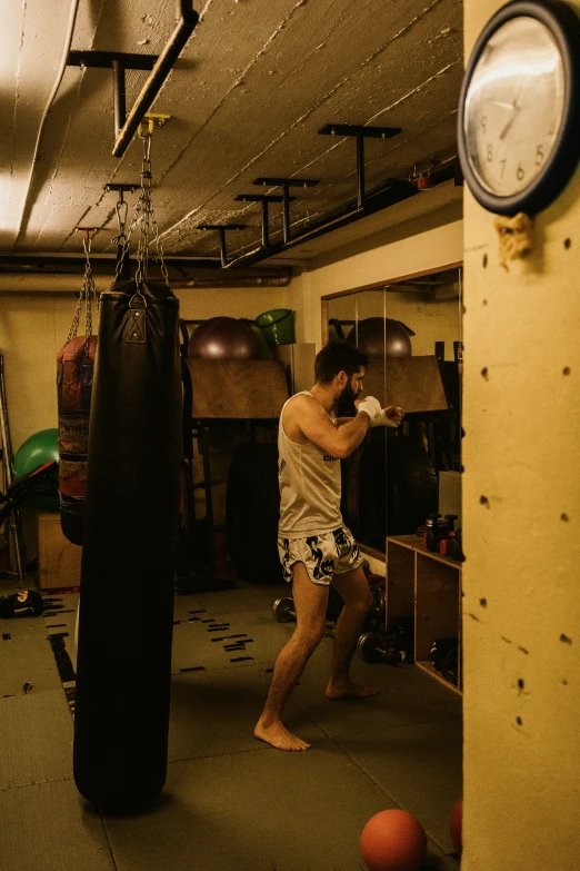 a man in an indoor boxing ring swinging his punching glove