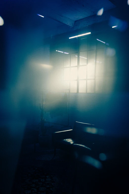 a fogy, darkened room with a chair in the background