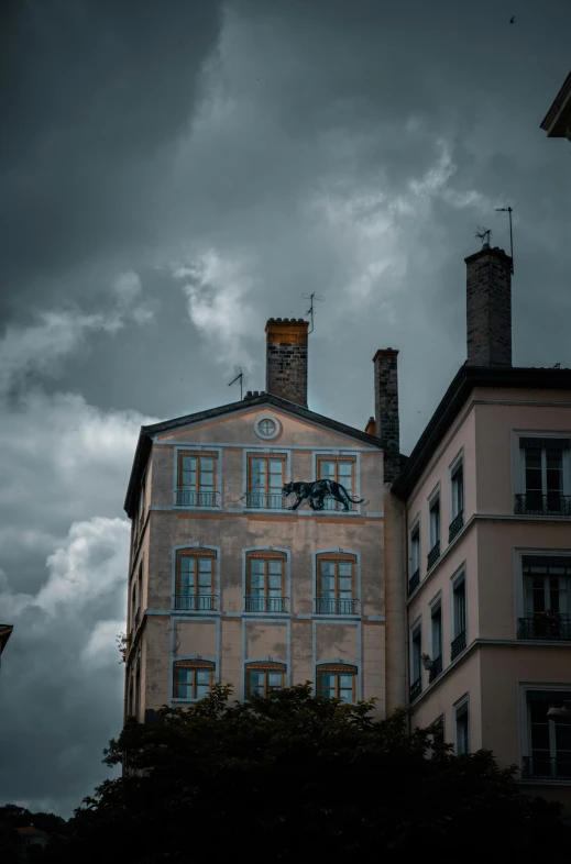 a large building with an overcast sky behind it