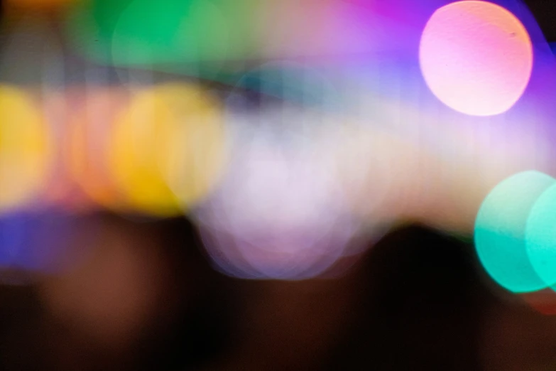 a colorful blurry image of a street with many different lights