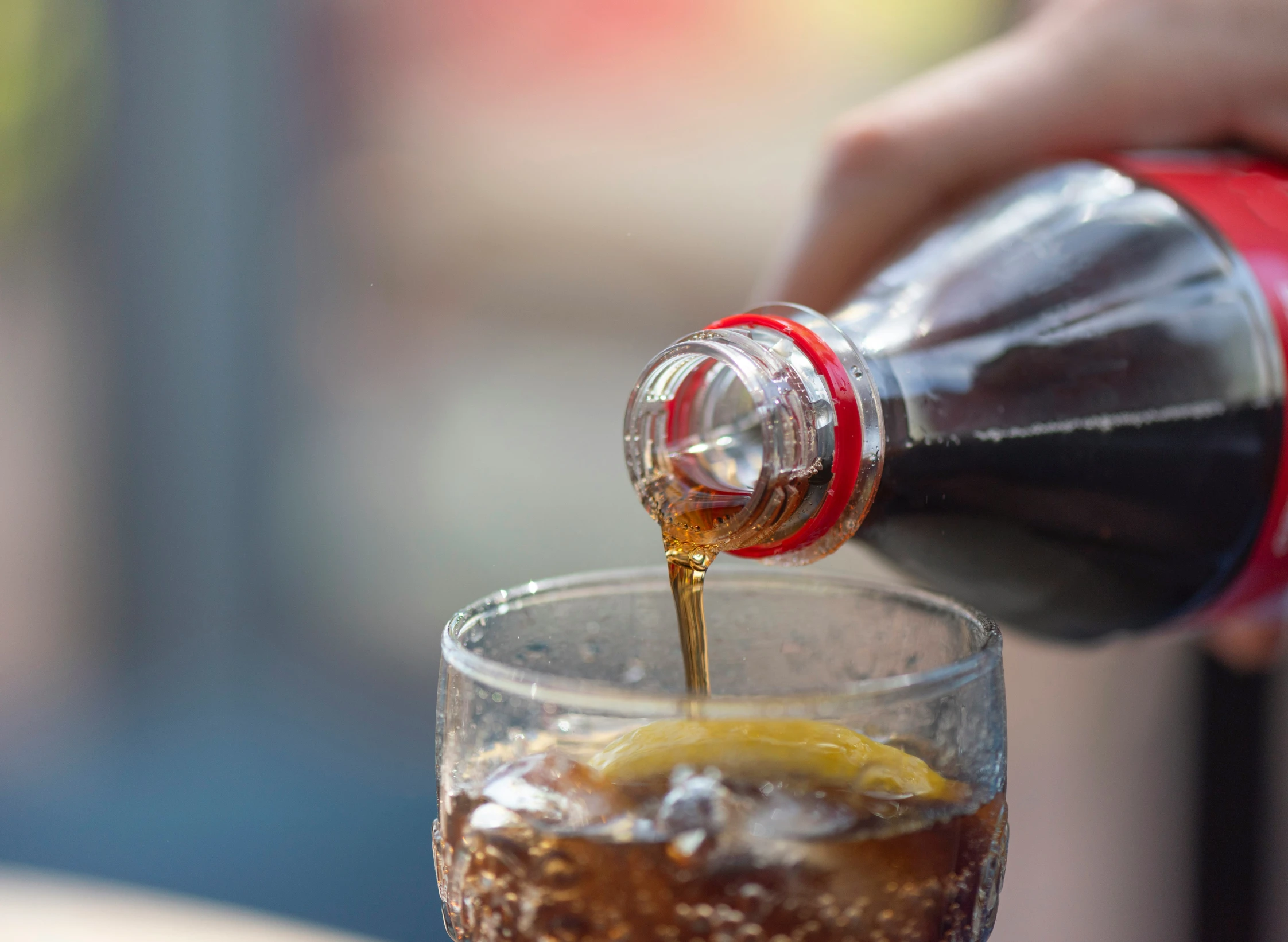 someone pouring some ice into a glass