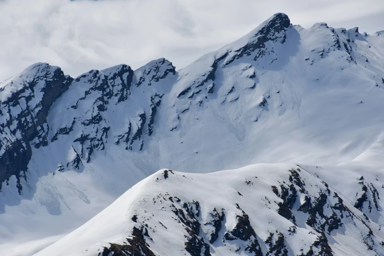 a view of snow capped mountain peaks in the distance