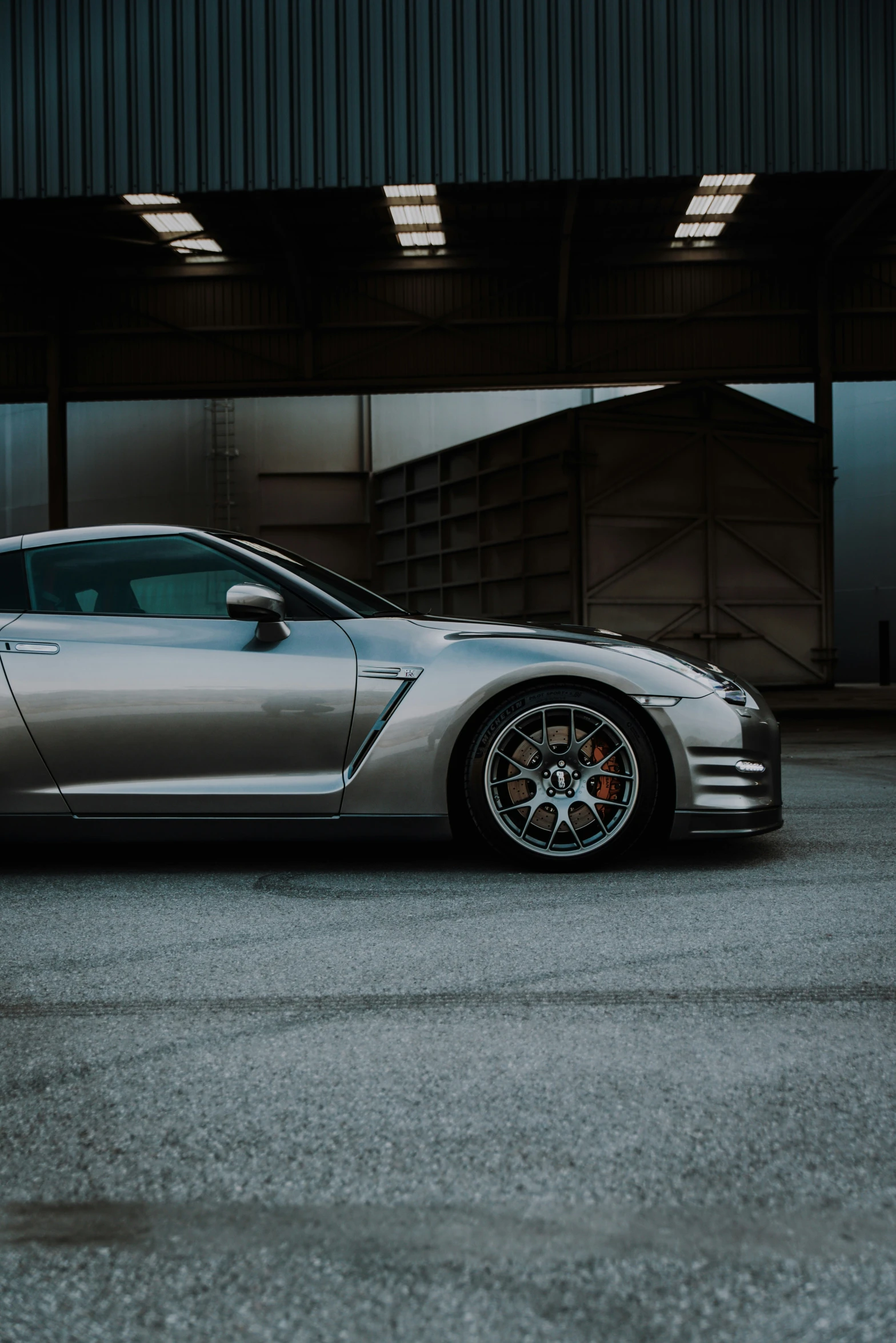 a gray car parked inside a garage