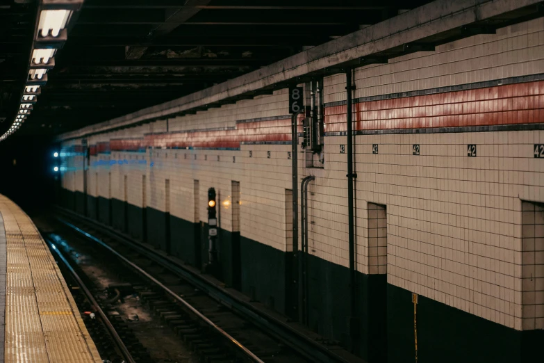 train pulls into a subway station with many tracks