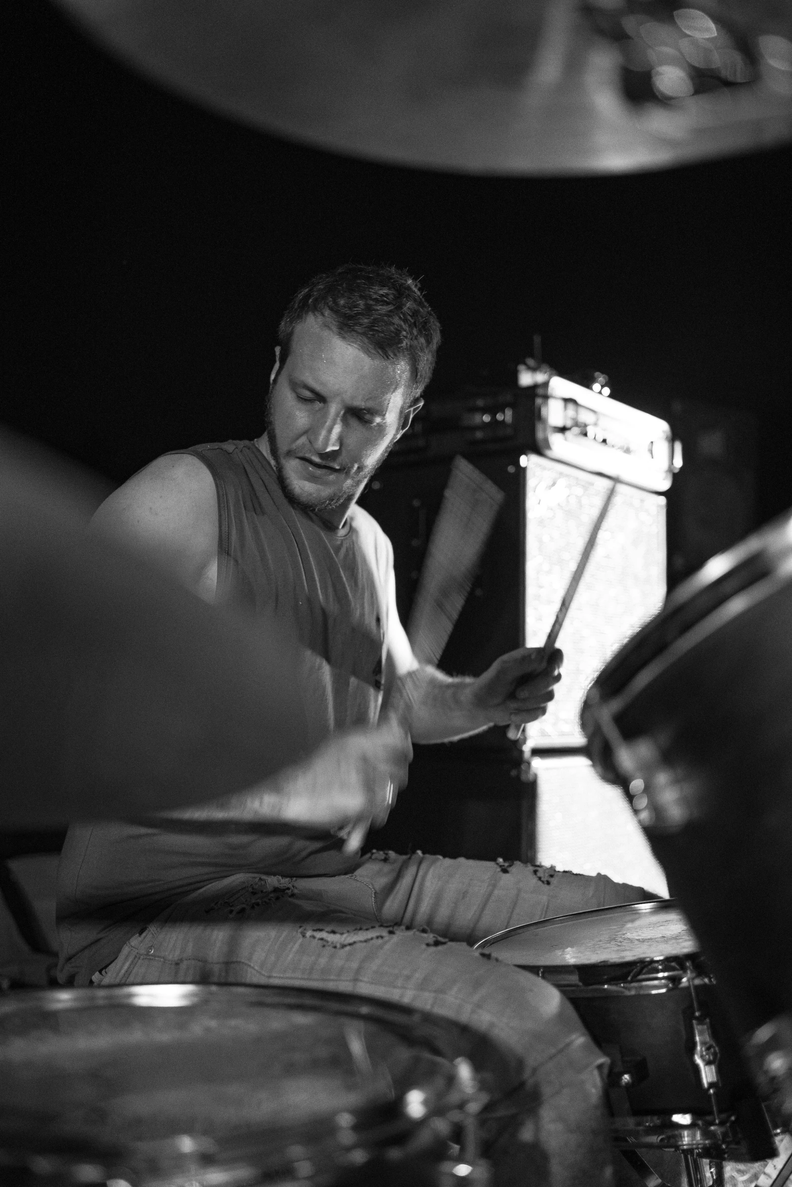 a man that is sitting in front of a drum set