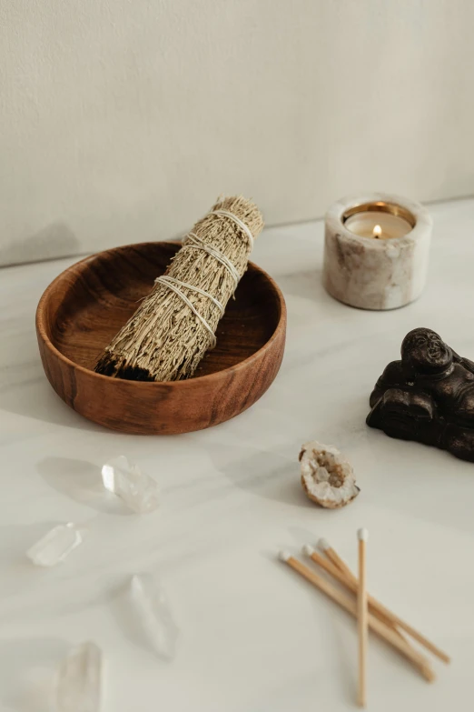 incense sticks, rock, and wood bowl on table