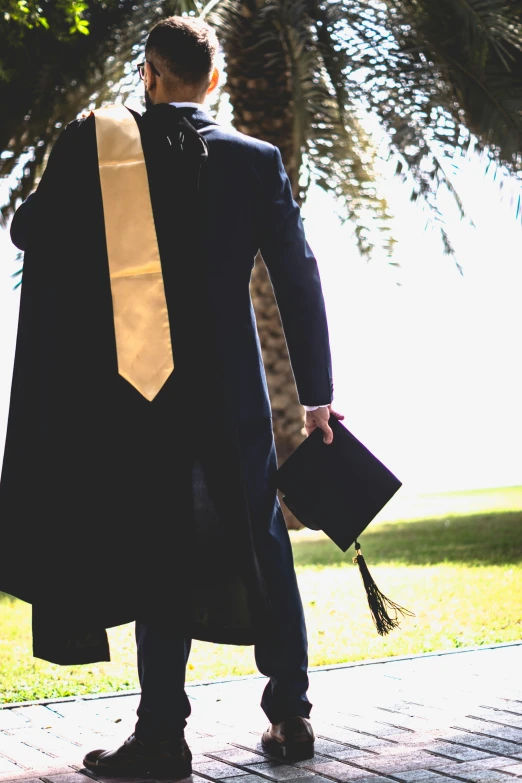 man dressed as judge is standing outside with handbag